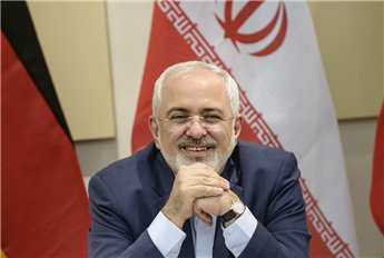 Iranian Foreign Minister Javad Zarif smiles before a meeting on Iran's nuclear program with Britain, Russia, China, France, Germany, European Union...