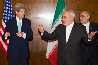 Secretary of State John Kerry discusses seating arrangements for a meeting with Iranian Foreign Minister Mohammad Javad Zarif  during a round of...