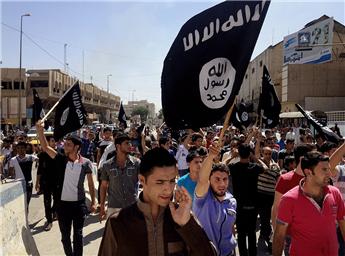 Demonstrators carry Islamic State flags through the streets of Mosul, Iraq, on June 16, 2014.  AP