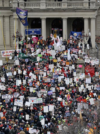 Protesters gather for a rally at the State Capitol in Lansing, Mich., where Gov. Rick Snyder signed right-to-work legislation Tuesday, dealing a...