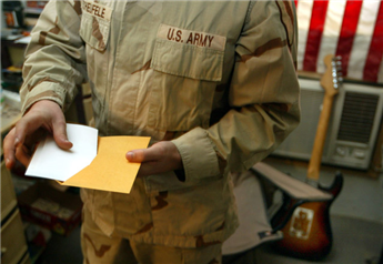 A soldier prepares to mail in his completed absentee ballot after voting in the American Presidential and Congressional election while at Camp Eagle...