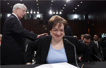 Supreme Court nominee Elena Kagan gets a pat on her back as she takes her seat on Capitol Hill in Washington, Wednesday, June 30, 2010, prior to the...