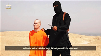 An Islamic State terrorist points a knife at James Foley shortly before the journalist was beheaded.