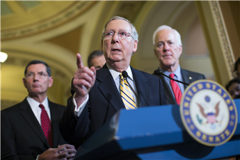 Senate Majority Leader Sen. Mitch McConnell answers questions during a news conference on Capitol Hill on Tuesday. From left are Sen. John Barrasso,...