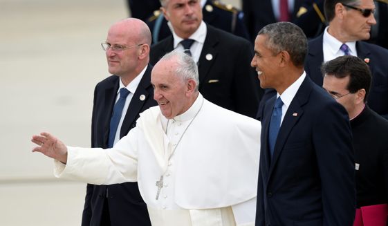 Pope Francis, center, walks with President Barack Obama, right, after arriving at Andrews Air Force Base in Md., Tuesday, Sept. 22, 2015. The Pope is spending three days in Washington before heading to New York and Philadelphia. This is the Pope&#39;s first visit to the United States. (AP Photo/Susan Walsh)