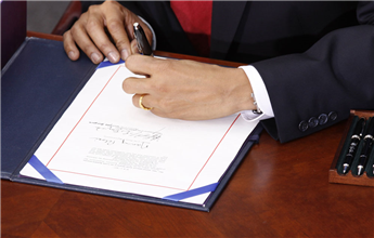 President Obama signs the economic stimulus bill in Denver on Feb. 17, 2009. AP
